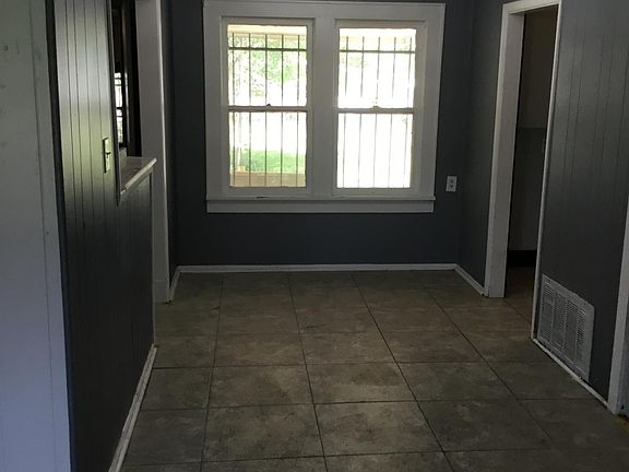 Dining area with wagon wheel fixture/ ceramic tile floor
