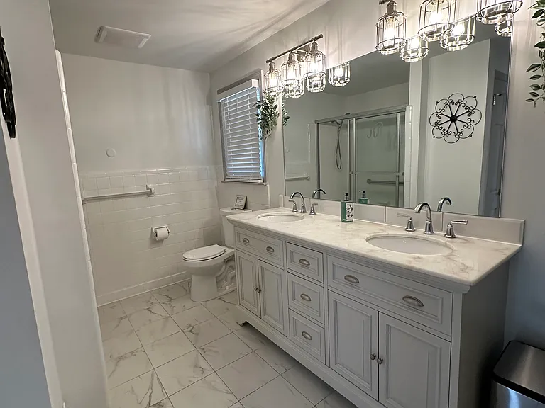 Spacious master bedroom featuring a private bathroom for ultimate convenience and luxury.