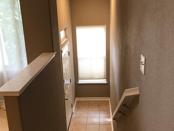 Stairs to backdoor leading to deck and back and side yards