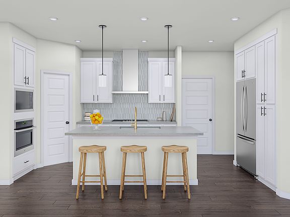 A modern, bright kitchen with white cabinets, a gray countertop, and three wooden bar stools in the