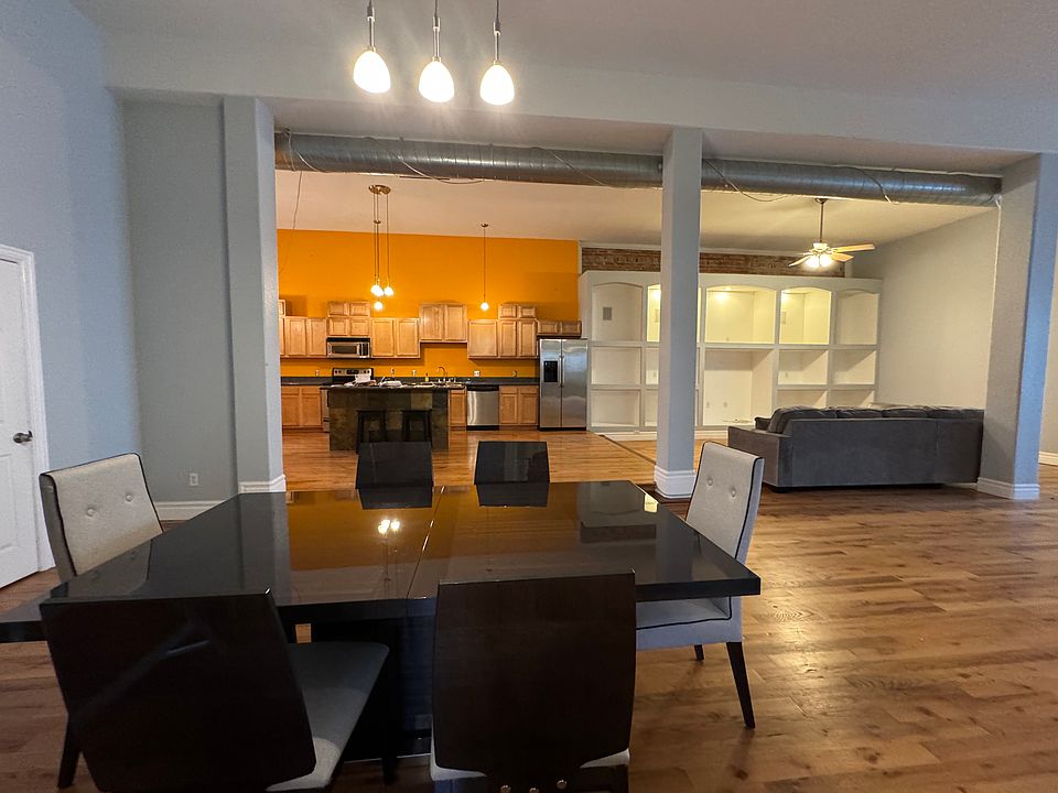 View from dinning room into the kitchen and built-in shelves in living room area.
