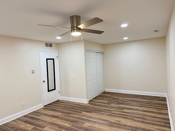 View from bedroom far corner showing entrance and nook