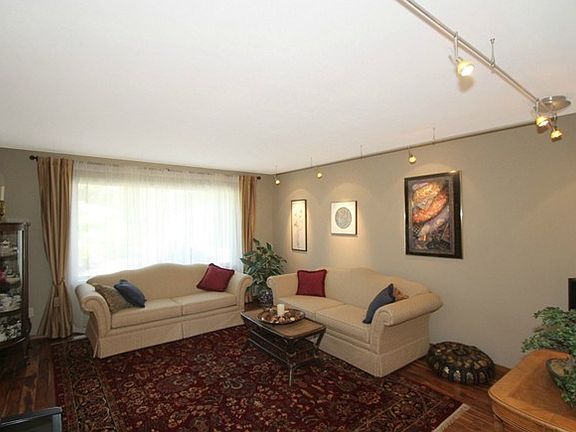 The living room is just one of the gathering places in this comf