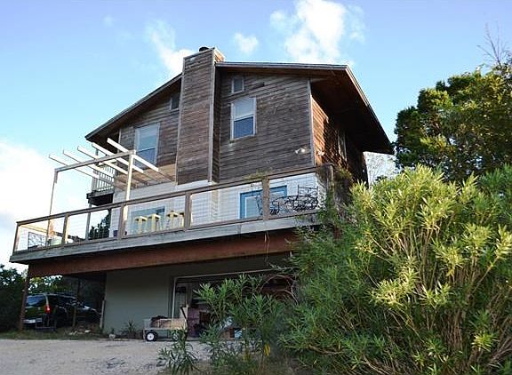 Three story cedar/brick home with two-car garage