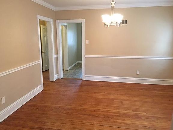 Separate dining room with chair rail and crown molding.