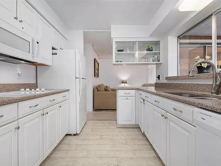 Kitchen towards family room.
(Upper glass cabinet has been removed)