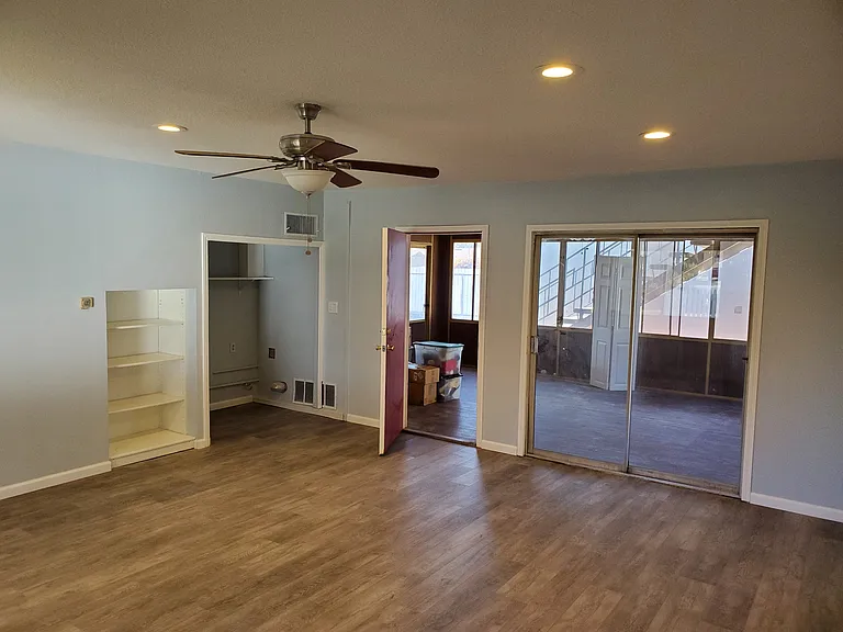 2nd living room showing laundry area and leading to bonus sunroom