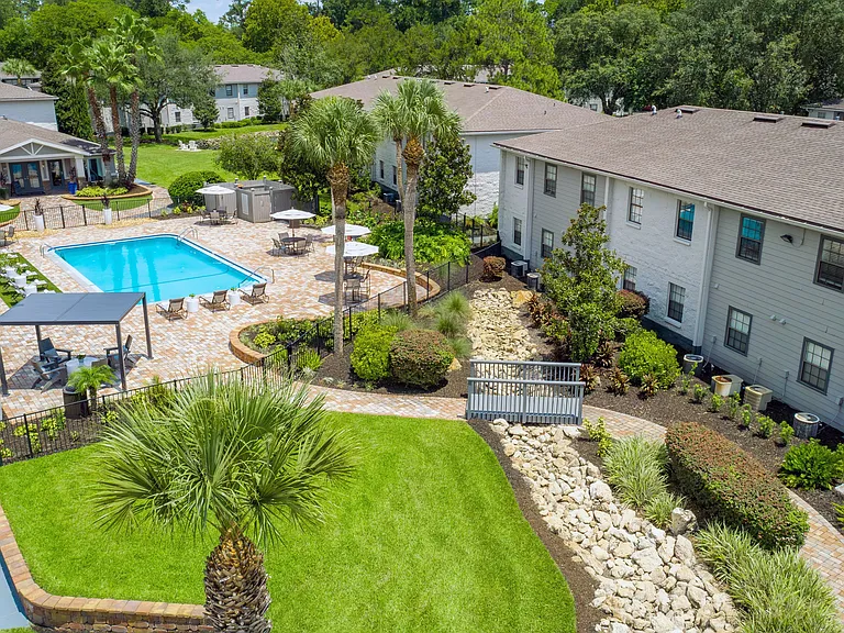 Soar high for a breathtaking view of the resort-style pool, expansive sundeck, and elegantly paved walkway.