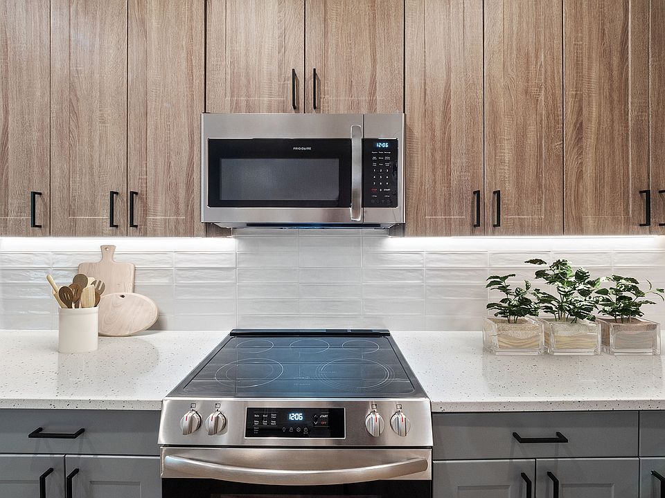 Sleek, two-toned European kitchen cabinets with under-cabinet lighting &amp; soft-close drawers and doors