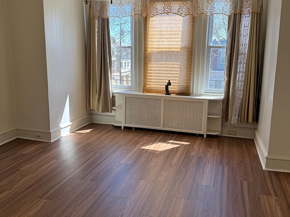 Front Room can be used as a spacious living room or bedroom. New flooring.
