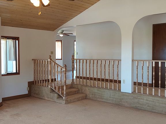 Living room - shows the small nook near kitchen stairs where a 4' desk could fit! Most windows open to allow for beautiful breezes.
