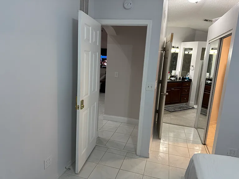 Hallway to main bathroom and closet