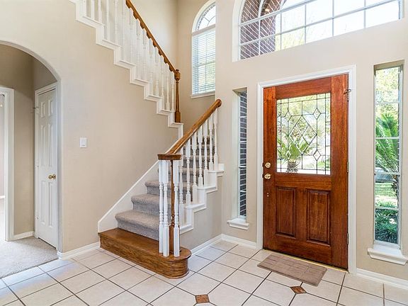 Gorgeous wood door with leaded glass will greet your guests. The abundant windows allow so much light into the home.