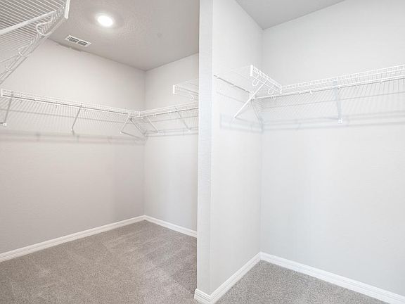 Walk-in wardrobe in owner s suite - Capri home plan by Highland Homes