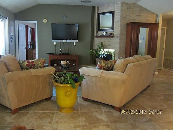 View of Family room with pretty tile flooring and corner fireplace