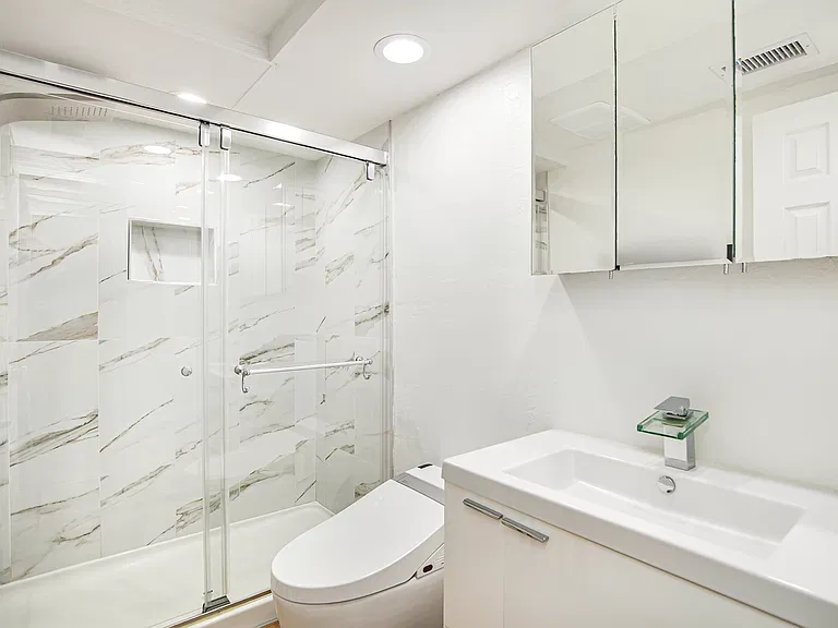 Bathroom featuring floating vanity, cabinet and automatic bidet.
