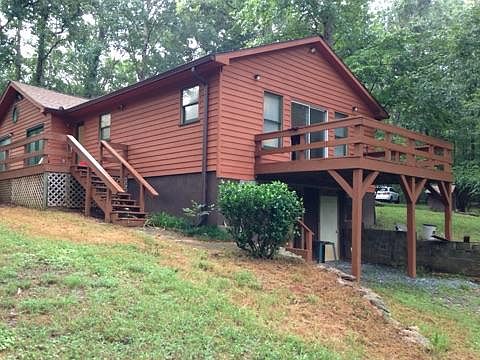 Rear of house with side balcony. Garage is located under balcony.