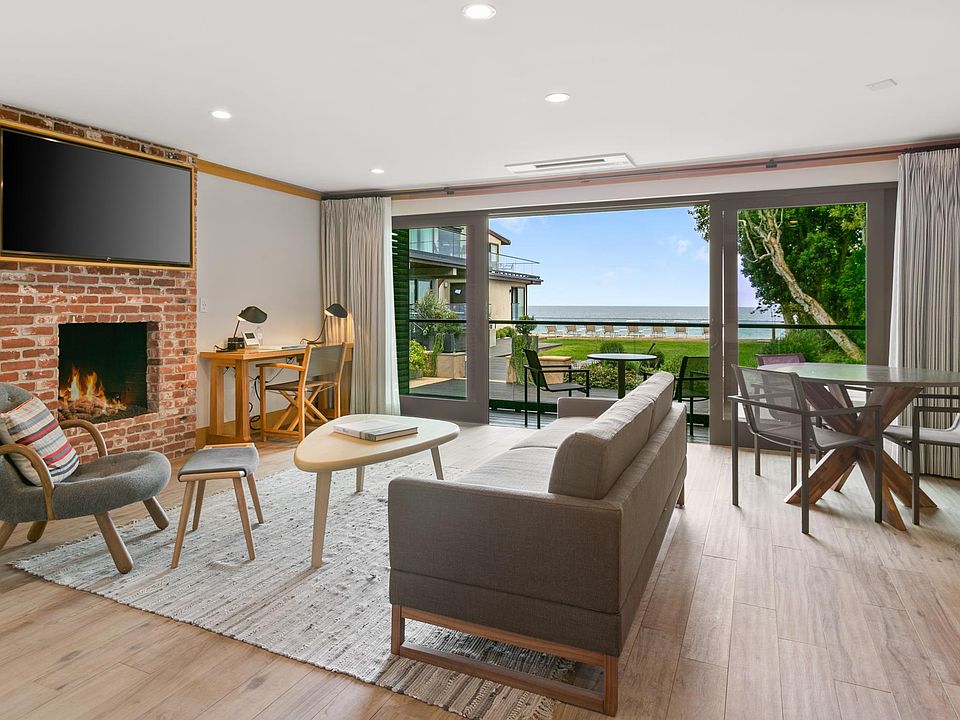 Get cozy next to the crackling fireplace as you take in views of the expansive Pacific Ocean.