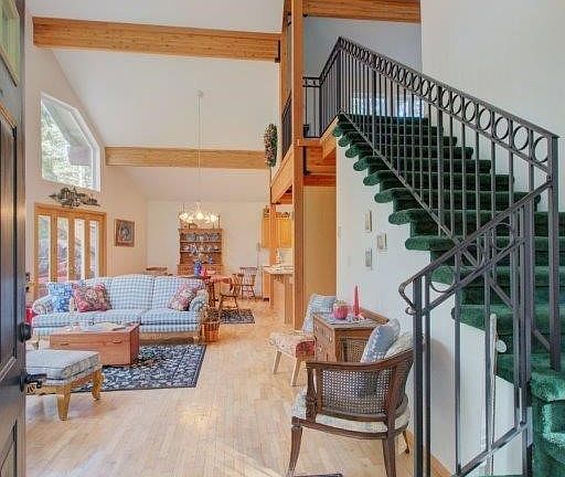 Grand entrance to the home with curved staircase to the left as you enter and living room and dining room across the front of th