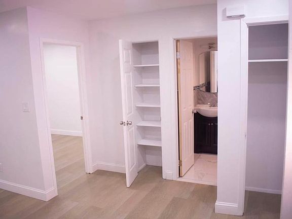 Point of view is from the kitchen, two closets before entering the bedroom and the bathroom is in between.