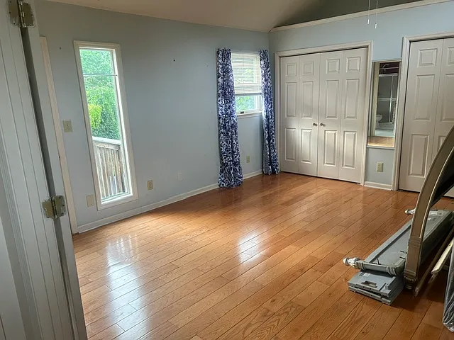 Master bedroom with vaulted ceiling and again lots of windows making this a bright spot for relaxing
