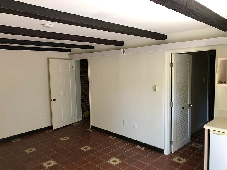 Guest suite main room. Entrance door, and then the door to the bathroom