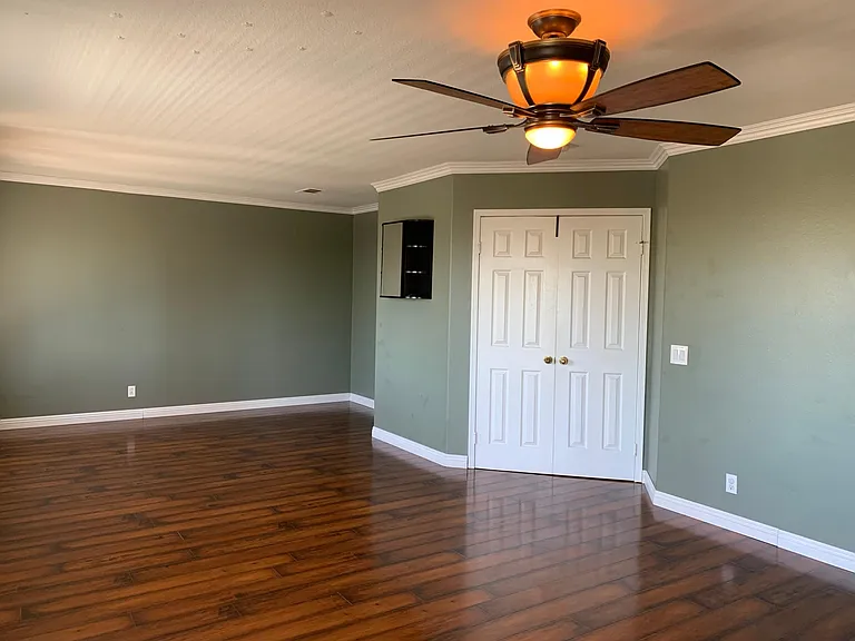 Very large master bedroom with natural light and entertainment space.