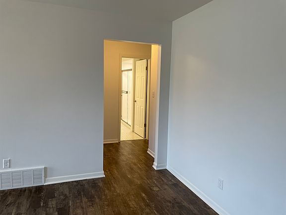 Living room looking into hallway and bathroom.