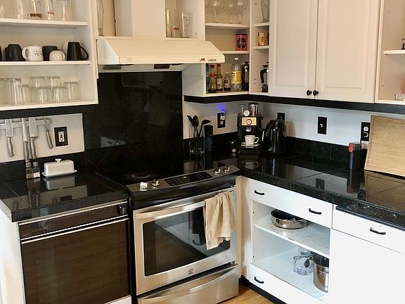 A large kitchen with lots of countertops and cupboards.