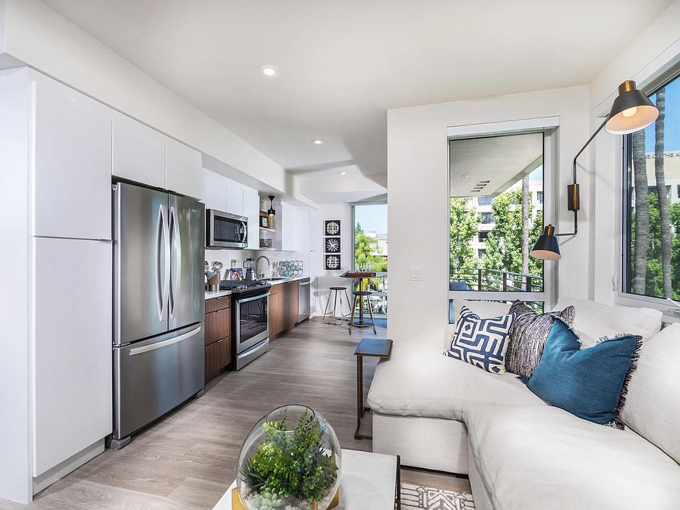 Bright kitchen with moveable island option and elegant open_shelving design.