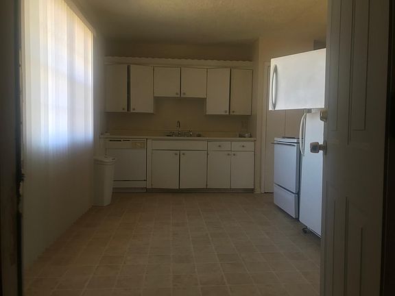 Beautiful kitchen with stove, refrigerator, and dishwasher. Pantry & broom closet.