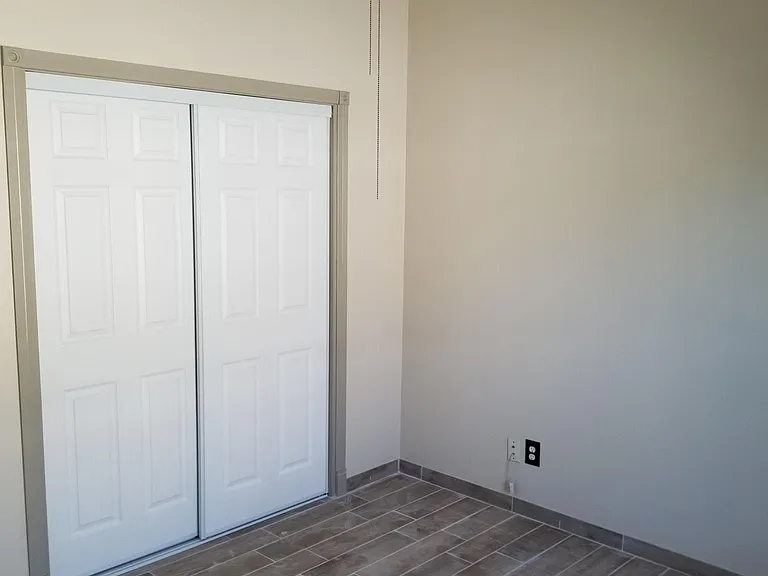 Bedroom 1- beautifully redone- new flooring/closet and fresh paint.