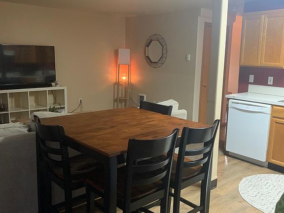 standing by back door looking through dining to living room