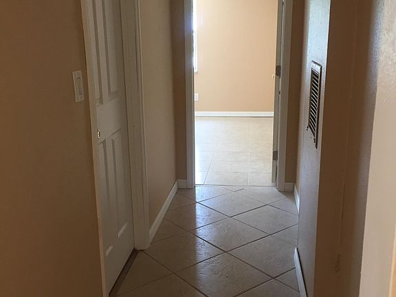 Hallway to laundry room on left and 3rd bedroom