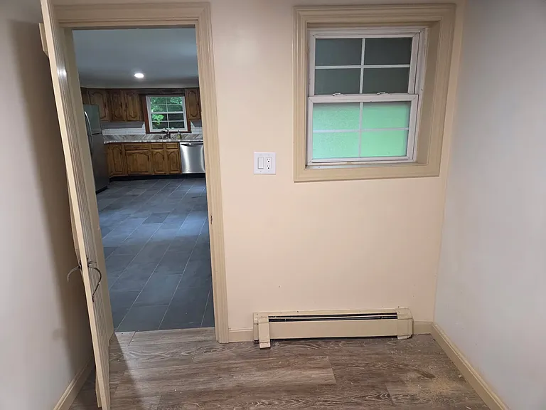 Small bonus room off the kitchen that could be used as an office, pantry, playroom, or for extra storage.