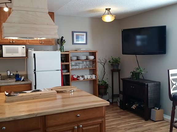 Kitchen and wall-mounted flatscreen.