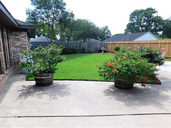 Extended patio with lush landscaping