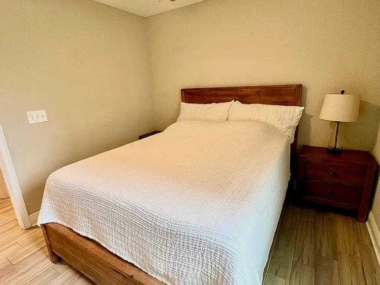Bedroom three with queen sized bed and nightstand