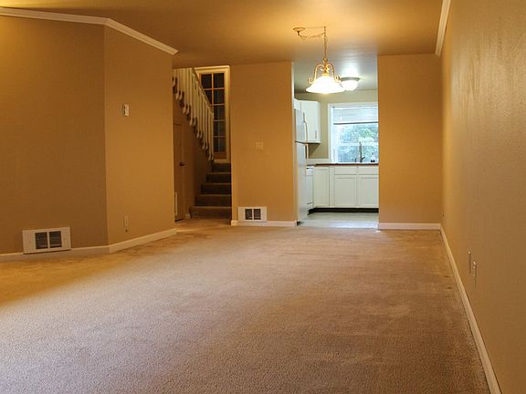 Living room facing entryway and kitchen