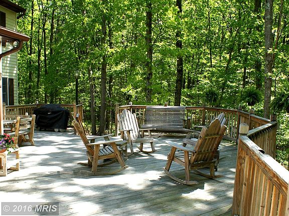 Expansive Rear Deck Under Shade Tree Umbrellas