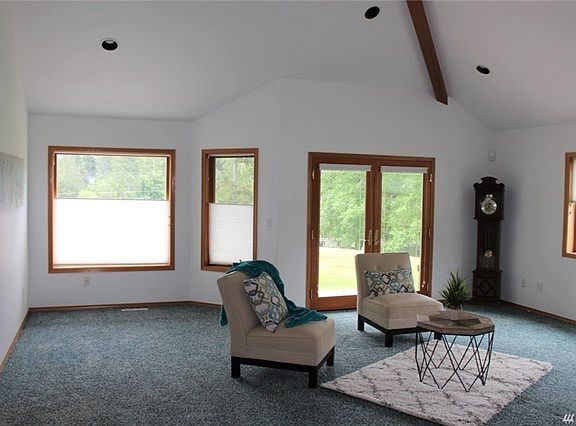 Another view of great room. with vaulted ceiling with beam detail.  French doors lead to patio.