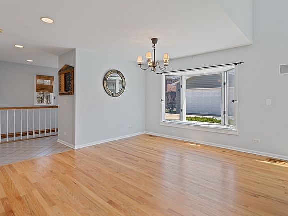 Large breakfast room with bay window overlooking backyard.