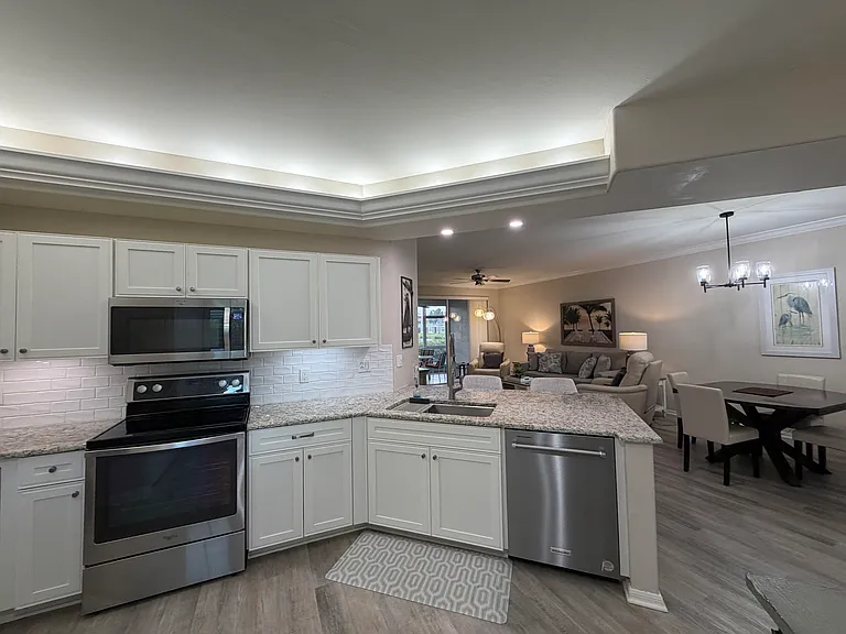Condo opened up (wall removed, was on right of counter) for seamless view to living room and lanai from kitchen.