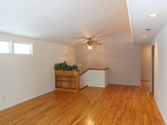 Living room features gorgeous oak hardwood flooring. Cathedral ceilings with indirect lighting.
