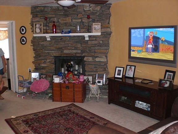 Living room w/ rock fireplace