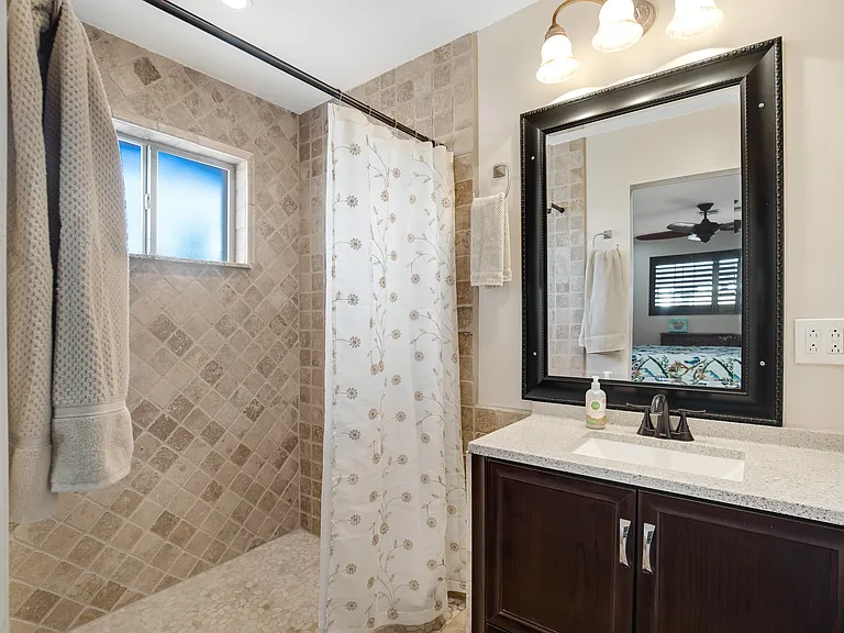 Private bathroom with curbless shower.
