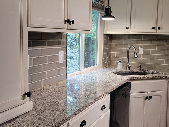 Remodeled kitchen with quartz counters and subway tiles