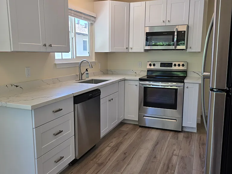 Remodeled Kitchen with stainless steel appliances, new cabinets and quartz countertops.