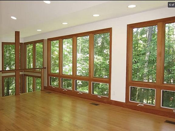 floor-to-ceiling windows with treetop views