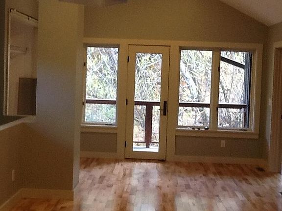 living room and door to covered Creekside deck